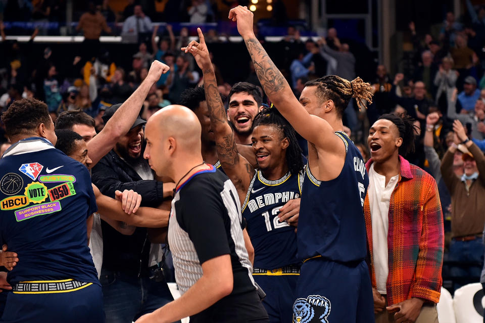 MEMPHIS, TENNESSEE - FEBRUARY 28: Ja Morant #12 of the Memphis Grizzlies celebrates with teammates during the first half against the San Antonio Spurs at FedExForum on February 28, 2022 in Memphis, Tennessee. NOTE TO USER: User expressly acknowledges and agrees that, by downloading and or using this photograph, User is consenting to the terms and conditions of the Getty Images License Agreement. (Photo by Justin Ford/Getty Images)