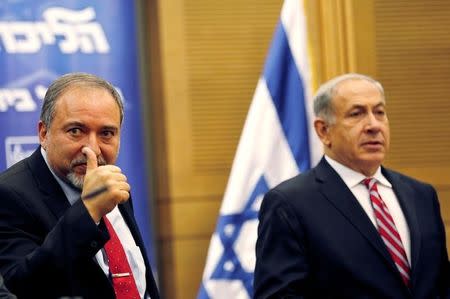 Israel's Prime Minister Benjamin Netanyahu (R) and Avigdor Lieberman attend a Likud-Beitenu faction meeting at the Knesset, the Israeli parliament, in Jerusalem November 11, 2013. REUTERS/Amir Cohen/File Photo