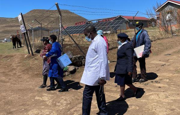 The Lesotho Flying Doctor Services team walks through a remote village in the mountainous southern African nation after arriving by plane to administer COVID-19 vaccinations. / Credit: CBS News