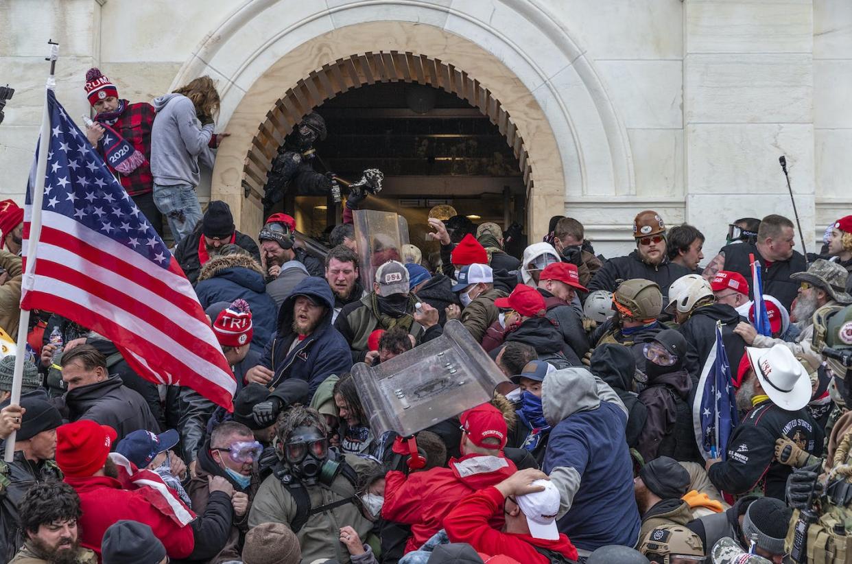 Rioters break windows and breach the Capitol building in an attempt to overturn the results of the 2020 presidential election. <a href="https://www.gettyimages.com/detail/news-photo/police-use-tear-gas-around-capitol-building-where-pro-trump-news-photo/1230464979" rel="nofollow noopener" target="_blank" data-ylk="slk:Lev Radin/LightRocket via Getty Images;elm:context_link;itc:0;sec:content-canvas" class="link ">Lev Radin/LightRocket via Getty Images</a>