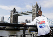 FILE - Britain's Mo Farah poses for the media at a photocall near Tower Bridge in London, Tuesday, April 17, 2018. It is hard to be first. Mo Farah this week went from being a gold medal-winning runner to the most prominent person ever to come forward as a victim of people trafficking. The four-time Olympic champion’s decision to tell the story of how he was exploited as a child gives a face to the often faceless victims of modern slavery, highlighting a crime that is often conflated with illegal immigration. (AP Photo/Kirsty Wigglesworth, FILE)