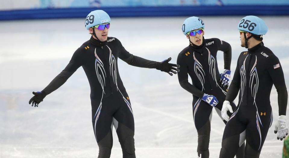 Skaters of the U.S. react after crashing during the men's 5,000 metres short track speed skating relay semi-final event at the Iceberg Skating Palace during the 2014 Sochi Winter Olympics February 13, 2014. REUTERS/Lucy Nicholson (RUSSIA - Tags: SPORT SPEED SKATING OLYMPICS)