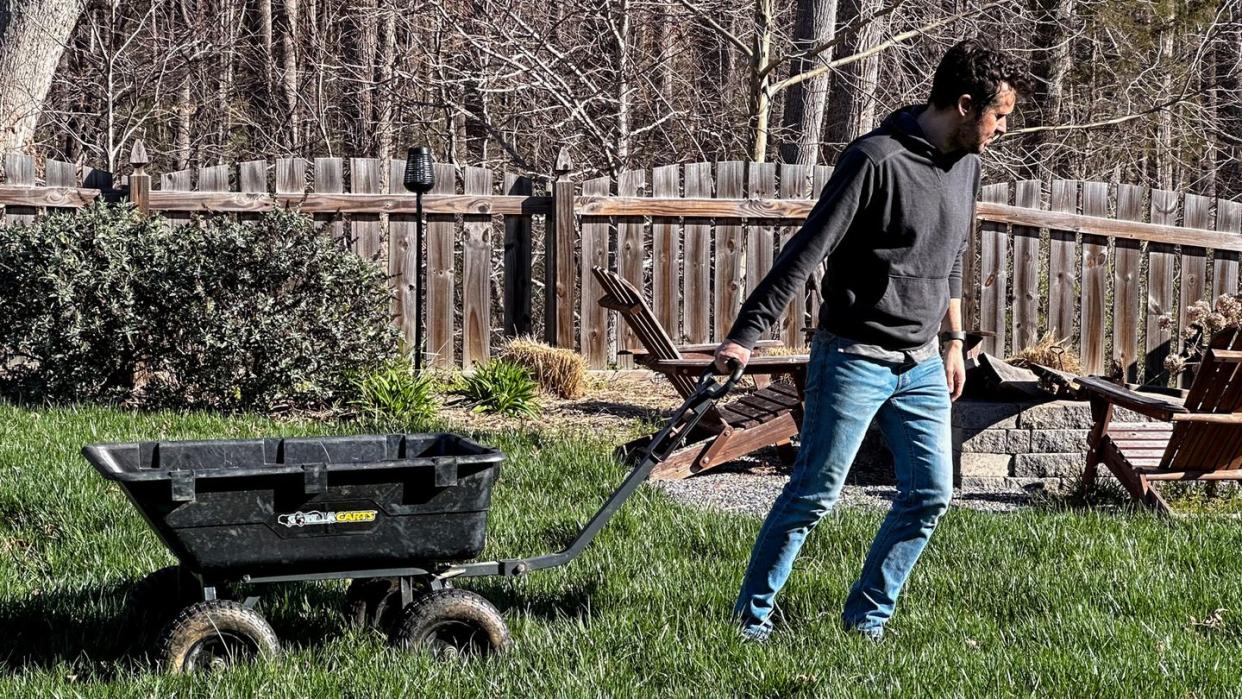 a person pushing a wheelbarrow