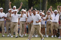 Tom Kim, of South Korea, celebrates after winning the 18th hole during their fourball match at the Presidents Cup golf tournament at the Quail Hollow Club, Saturday, Sept. 24, 2022, in Charlotte, N.C. (AP Photo/Chris Carlson)