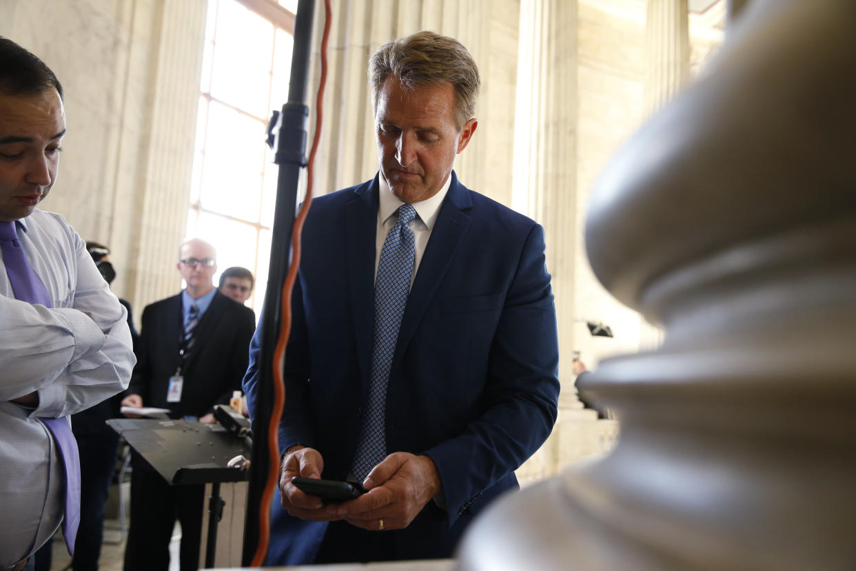 Sen.&nbsp;Jeff Flake (R-Ariz.) pauses to check his phone after announcing he will not run for re-election on Oct. 24, 2017. (Photo: Joshua Roberts/Reuters)