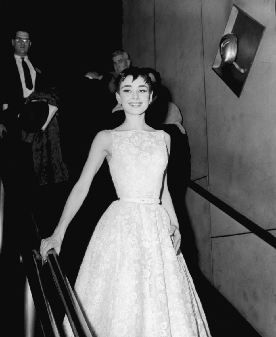 <p>The legendary actress attended the 26th Academy Awards in 1954 in a delicate, white lace floral gown by her go-to designer: Givenchy.</p> 