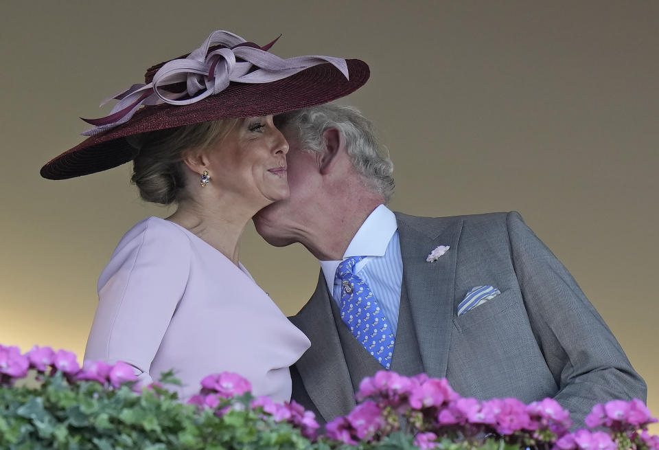 Britain's Prince Charles greets Sophie, Countess of Wessex, in the stands on day one of the Royal Ascot horse racing meeting, at Ascot Racecourse, in Ascot, England, Tuesday June 14, 2022. (AP Photo/Alastair Grant)