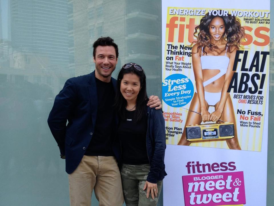 Ortiz standing next to a Fitness Magazine banner. Celebrity chef Rocco DiSpirito is standing next to her.