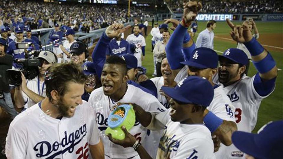 Dodgers ace Clayton Kershaw, left, is mobbed by his teammates after throwing a no-hitter against the