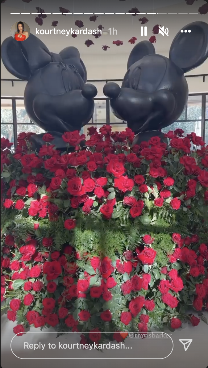 Dozens of roses surrounded by Mickey and Minnie Mouse.