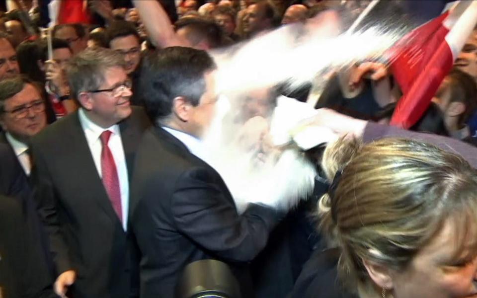 A man throws flour on French presidential candidate Francois Fillon - Credit: JULIEN SENGEL/AFP