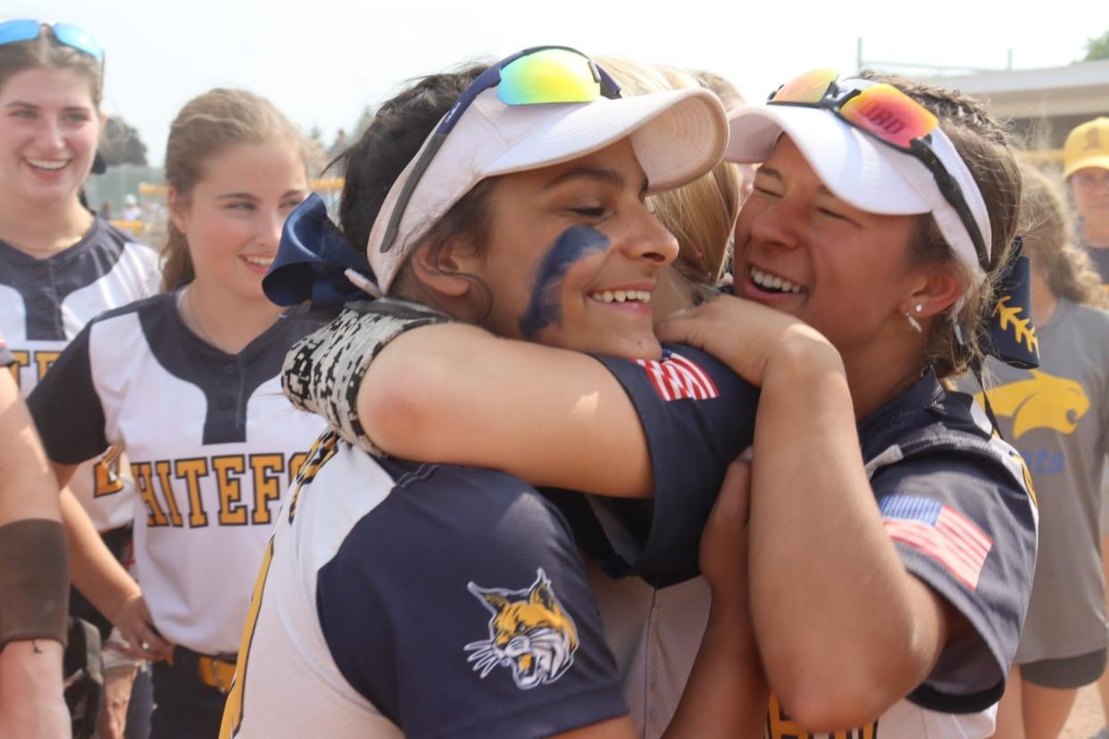 Whiteford’s softball players hug after winning a Regional championship Saturday.
