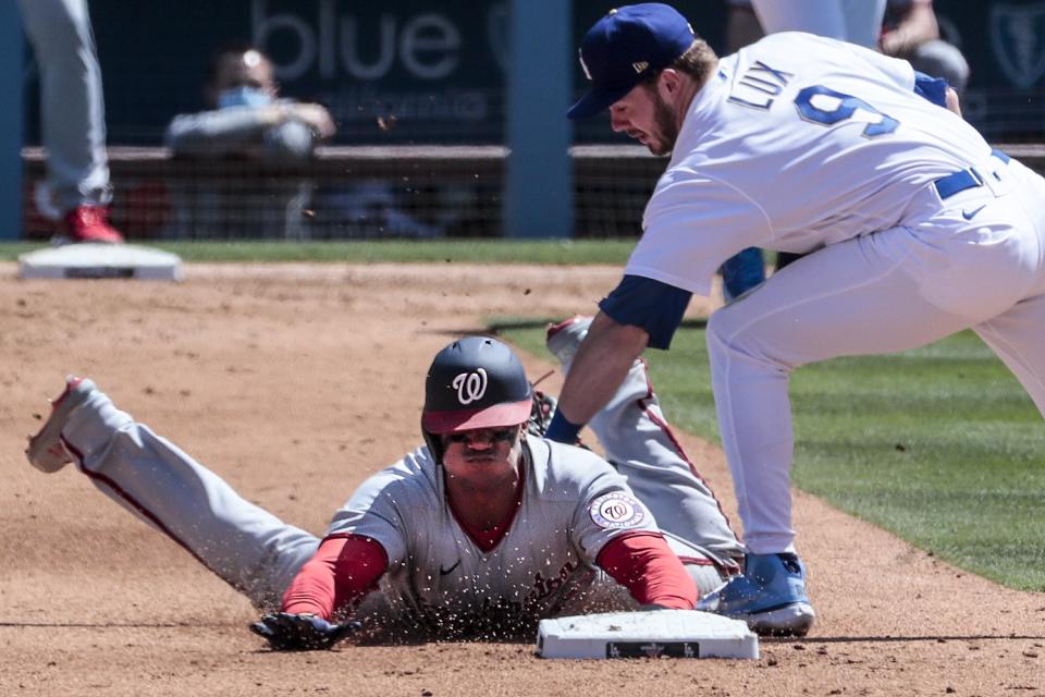 Washington Nationals left fielder Juan Soto (22) is tagged out stealing by Los Angeles Dodgers second baseman Gavin Lux.