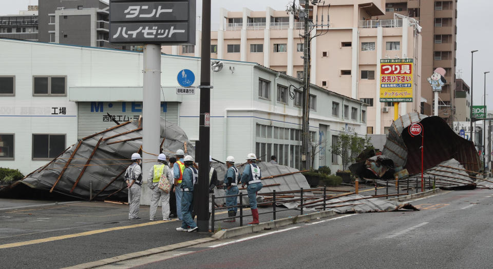 The roofs of a car factory are seen on sidewalk after typhoon hit Fukuoka, southwestern Japan Monday, Sept. 7, 2020. The second powerful typhoon to slam Japan in a week left people injured, damaged buildings, caused blackouts at nearly half a million homes and paralyzed traffic in southern Japanese islands before headed to South Korea.(Kyodo News via AP)