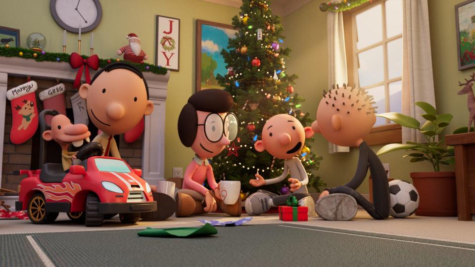 The Heffley family – little Manny (voiced by Gracen Newton, far left), dad Frank (Chris Diamantopoulos), mom Susan (Erica Cerra), and brothers Greg (Wesley Kimmel) and Rodrick (Hunter Dillon) – gather round the tree in "Diary of a Wimpy Kid Christmas: Cabin Fever."