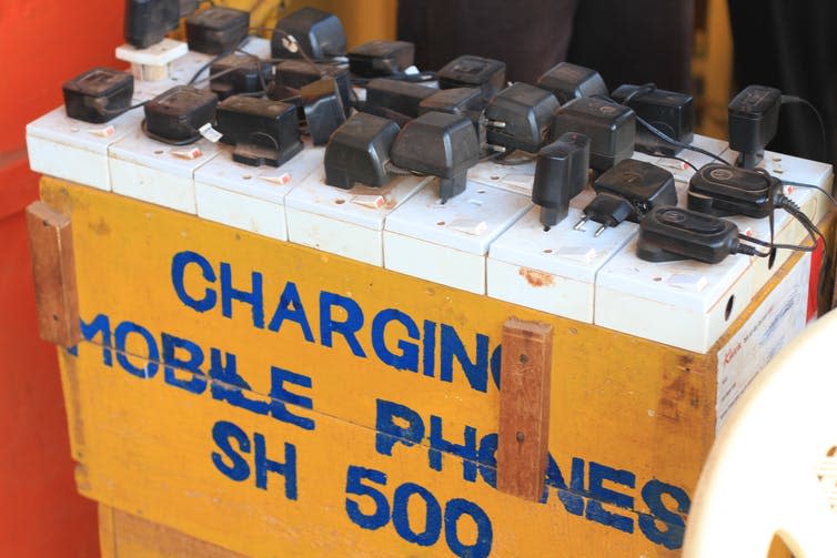 Plugs are plugged into a box marked 'CHARGING MOBILE PHONES SH 500'