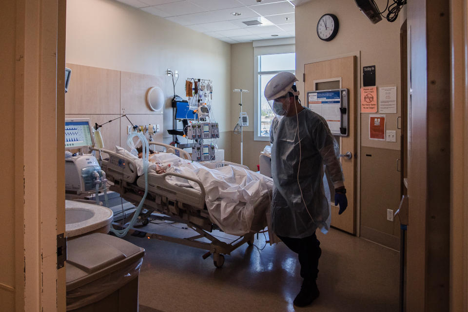 A Healthcare worker checks on a patient in the Covid-19 Intensive Care Unit (ICU) overflow area at Providence Holy Cross Medical Center in Mission Hills, California, U.S., on Friday, Feb. 5, 2021. (Ariana Drehsler/Bloomberg via Getty Images)