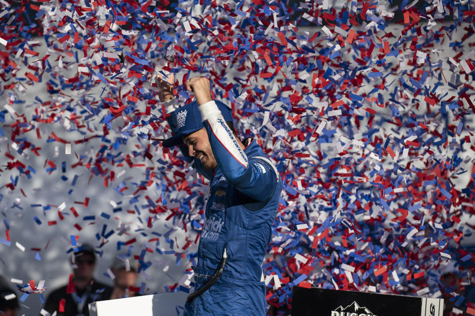 Kyle Larson celebrates in Victory Lane after winning a NASCAR Cup Series auto racing race at Charlotte Motor Speedway, Sunday, Oct. 10, 2021, in Concord, N.C. (AP Photo/Matt Kelley)