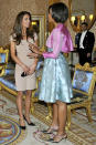 Photo by: AP<br>Meeting the new Duchess-<br>The first lady chatted with the newly minted Duchess of Cambridge while wearing a shiny, icy-blue Barbara Tfan dress and a swingy pink bolero jacket (we love the gun-metal slingback stilettos she's got on, too). But the duchess formerly known as <a rel="nofollow" href="http://shine.yahoo.com/channel/life/will-kate-middleton-vow-to-obey-her-prince-2469219" data-ylk="slk:Kate Middleton;elm:context_link;itc:0;sec:content-canvas" class="link ">Kate Middleton</a> had the style that wowed the crowd: Her tan bandage-style dress by Reiss Schola <a rel="nofollow" href="http://shine.yahoo.com/channel/beauty/kate-middletons-fashion-choices-create-retail-frenzy-and-tons-of-knockoffs-2448467#photoViewer=1" data-ylk="slk:sparked a fashion frenzy and sold out online almost as soon as these pictures went public.;elm:context_link;itc:0;sec:content-canvas" class="link ">sparked a fashion frenzy and sold out online almost as soon as these pictures went public.</a>