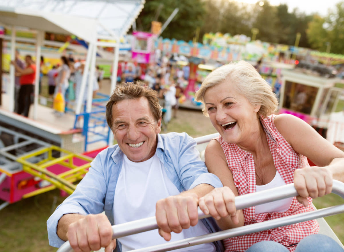 older couple enjoying a ride at a theme park or carnival