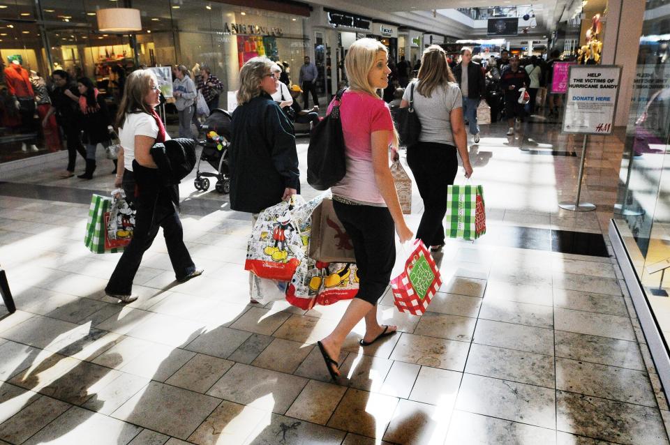Shoppers with their purchases at The Avenues mall on Black Friday, Nov. 23, 2021.