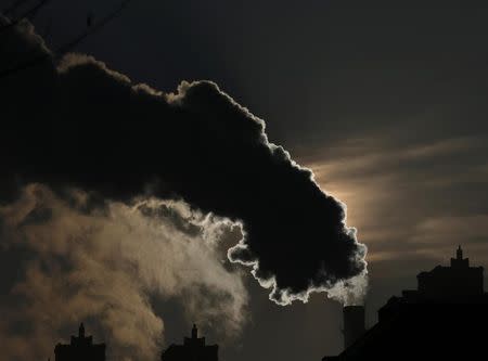 Smoke from a chimney is silhouetted against the rising sun in the northern city of Harbin, Heilongjiang province, January 6, 2014. REUTERS/Kim Kyung-Hoon