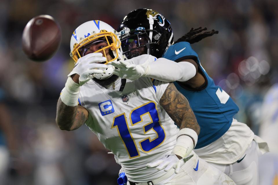 Jaguars cornerback Tre Herndon (37) defends a pass intended for Chargers receiver Keenan Allen during the first-round NFL playoff game in January.