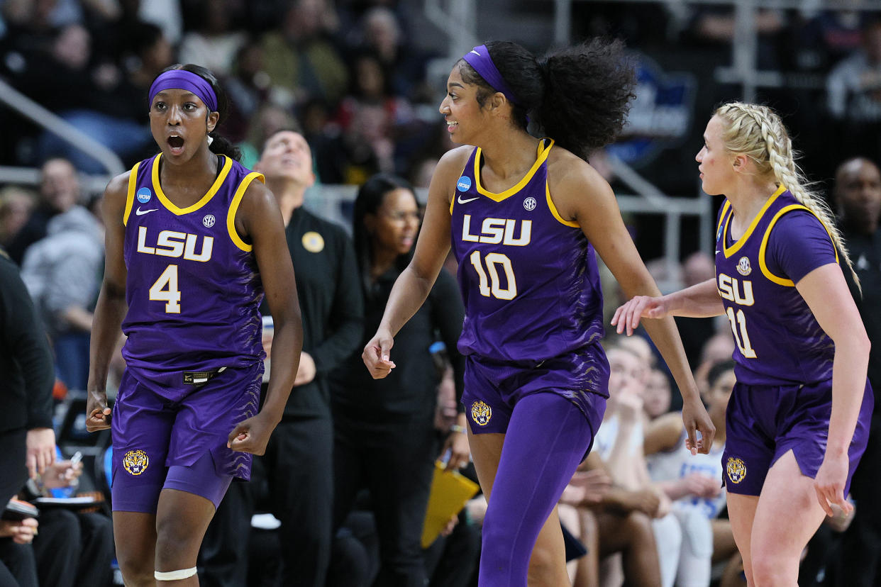 LSU's Flau'jae Johnson reacts with teammates Angel Reese and Hailey Van Lith during their win over UCLA on Saturday. (Andy Lyons/Getty Images)