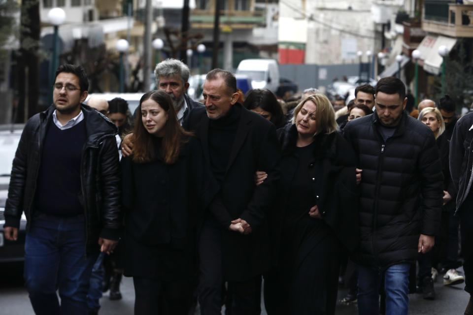 Mourners follow the funeral procession of 23-year old Ifigenia Mitska, at Giannitsa town, northern Greece, Saturday, March 4, 2023. Over 50 people — including several university students — died when a passenger train slammed into a freight carrier just before midnight Tuesday. The government has blamed human error and a railway official faces manslaughter charges. (AP Photo/Giannis Papanikos)
