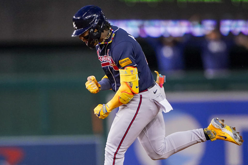 Atlanta Braves' Ronald Acuña Jr. celebrates as he runs the bases after hitting a solo home run during the first inning of a baseball game against the Washington Nationals at Nationals Park, Friday, Sept. 22, 2023, in Washington. With the hit, Acuña became the fifth player in MLB history with 40 home runs and 40 stolen bases in a season. (AP Photo/Andrew Harnik)