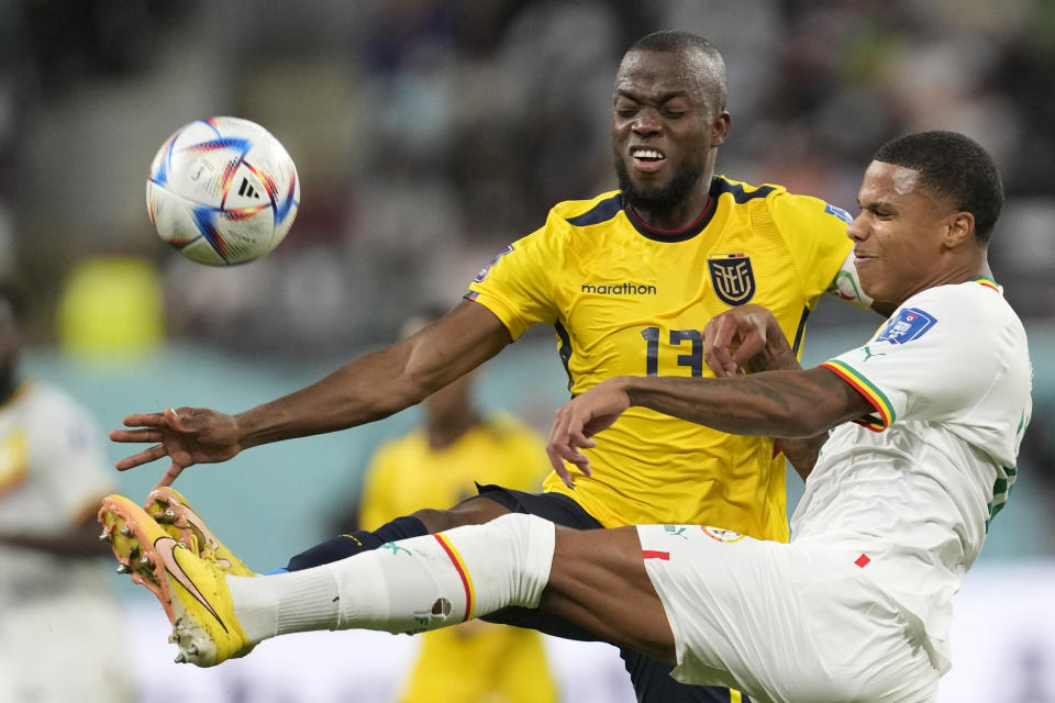 Senegal's Formose Mendy, right, and Ecuador's Enner Valencia challenge for the ball during the World Cup group A soccer match between Ecuador and Senegal, at the Khalifa International Stadium in Doha, Qatar, Tuesday, Nov. 29, 2022. (AP Photo/Darko Vojinovic)