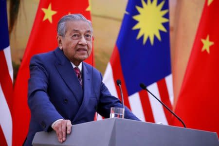 FILE PHOTO: Malaysia's Prime Minister Mahathir Mohamad speaks during a news conference with China's Premier Li Keqiang at the Great Hall of the People in Beijing, China, August, 20, 2018. How Hwee Young/Pool via REUTERS