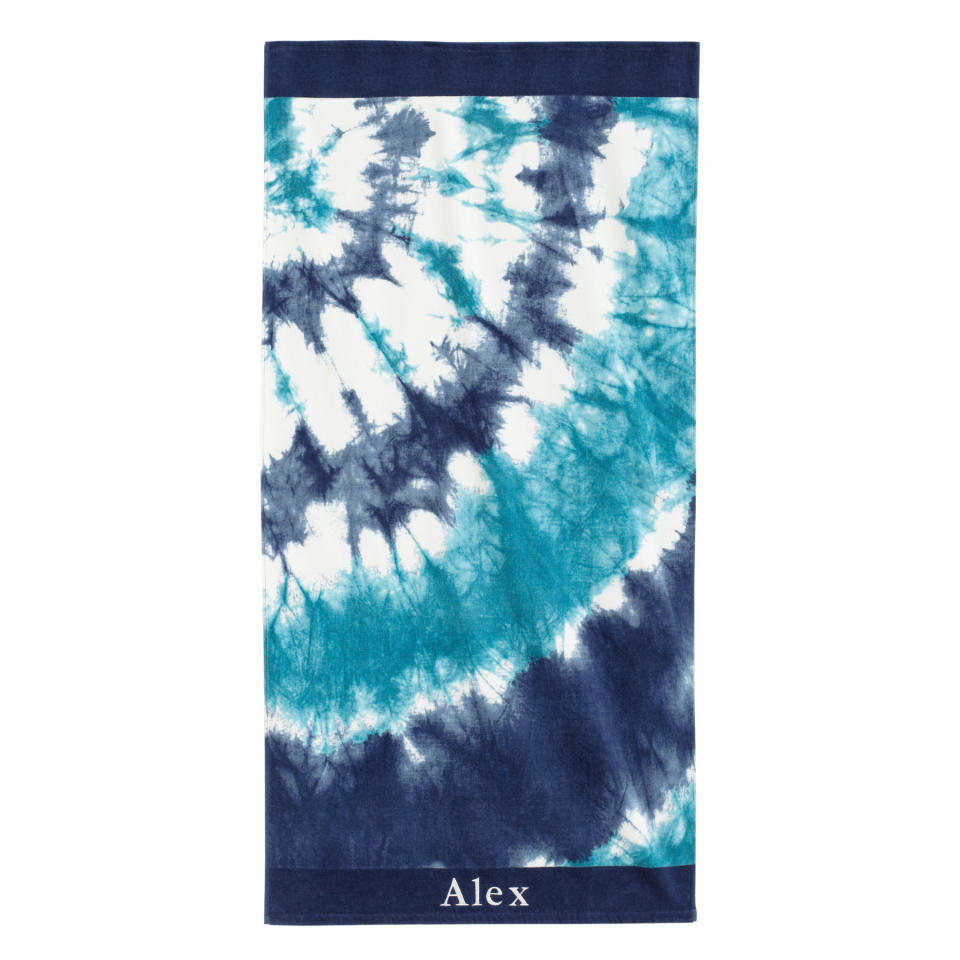 This product image released by Pottery Barn Teen shows a tie dye beach towel in blue. Pottery Barn Teen has towels with surfer-cool designs like hibiscus flowers, Tiki prints and tie-dye patterns in summery hues, as well as sporty towels for baseball fans, with team logos. (AP Photo/Pottery Barn Teen)