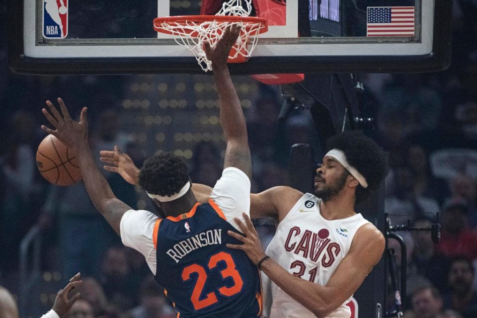 Cleveland Cavaliers'  Jarrett Allen (31) and New York Knicks'  Mitchell Robinson (23) goes for a rebound during Game 5 in their first-round playoff series Wednesday, April 26, 2023, in Cleveland.