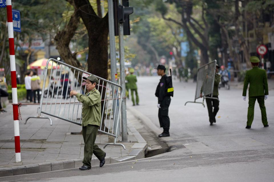 Volunteers move barriers to block roads ahead of motorcade of North Korean leader Kim Jong Un in Hanoi, Vietnam, Saturday, March 2, 2019. (AP Photo/Gemunu Amarasinghe)