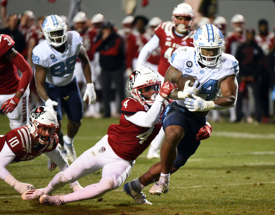 Nov 26, 2021; Raleigh, North Carolina, USA; North Carolina Tar Heels running back British Brooks (24) runs the ball during the first half against the North Carolina State Wolfpack at Carter-Finley Stadium. Mandatory Credit: Rob Kinnan-USA TODAY Sports