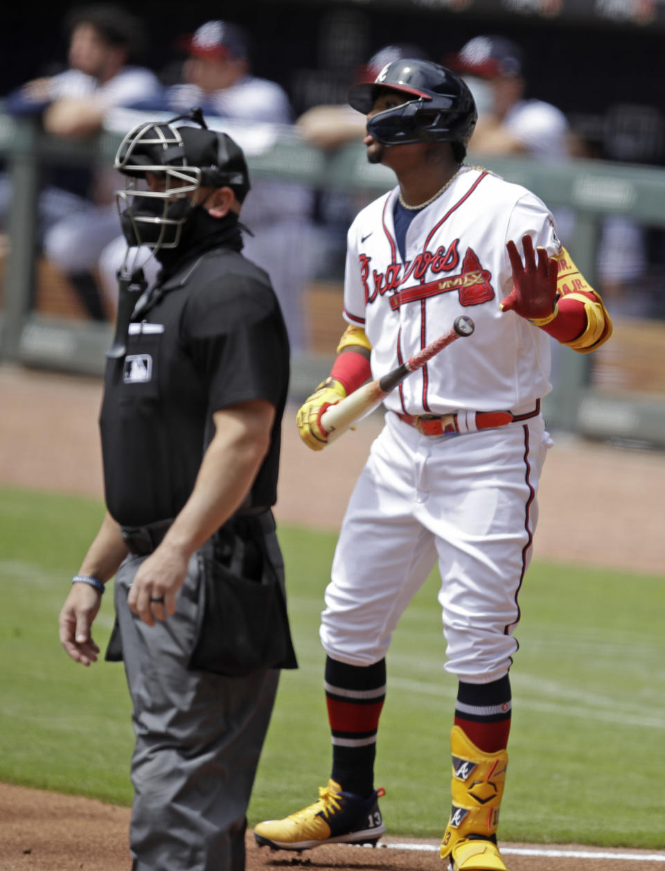 Atlanta Braves' Ronald Acuna Jr., right, watches to see if his home run hit off Toronto Blue Jays pitcher Ross Stripling stays fair in the first inning of a baseball game Thursday, May 13, 2021, in Atlanta. (AP Photo/Ben Margot)