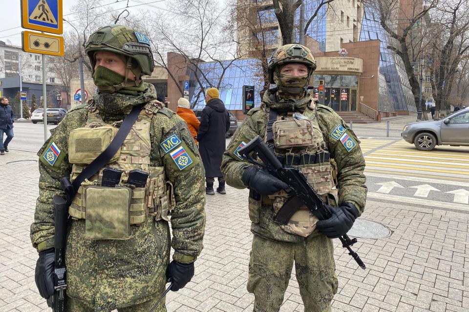 In this handout photo released by Russian Defense Ministry Press Service, Collective Security Treaty Organization peacekeepers guard an area in Almaty, Kazakhstan, Tuesday, Jan. 11, 2022. The president of Kazakhstan has announced that a Russia-led security alliance will start pulling out its troops from the country in two days after completing its mission. The mostly Russian troops were deployed to Kazakhstan last week by the Collective Security Treaty Organization, an alliance of six former Soviet states, at the president's request amid unprecedented public unrest. (Russian Defense Ministry Press Service via AP)