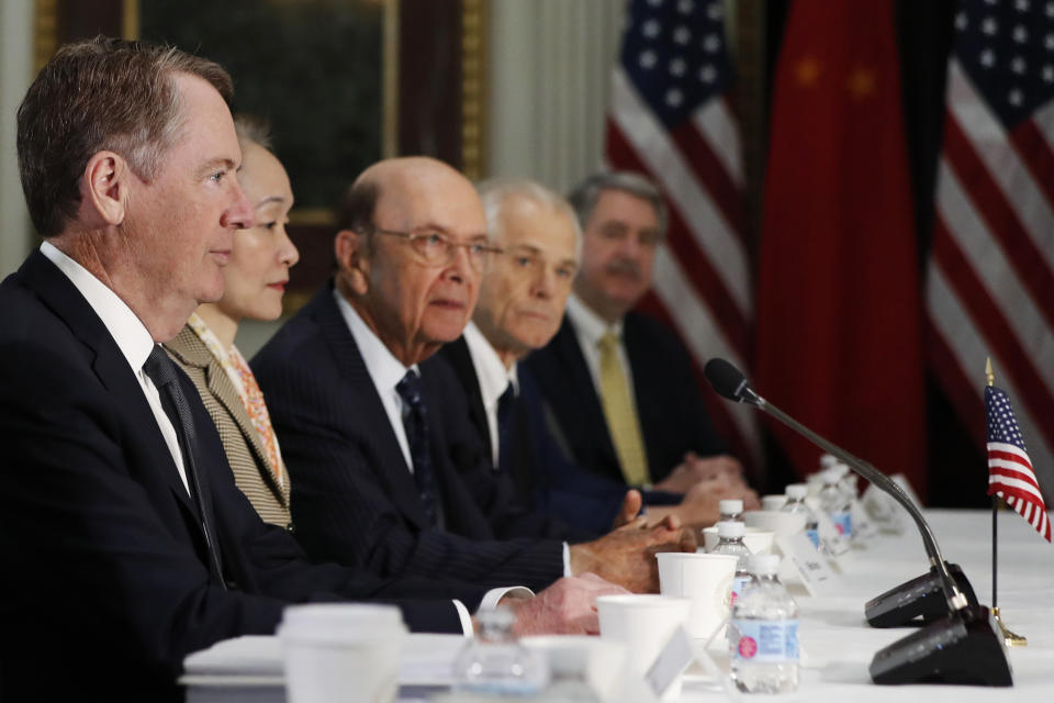 U.S. Trade Representative Robert Lighthizer, left, next to a translator, Commerce Secretary Wilbur Ross, and White House trade adviser Peter Navarro, attends a meeting of senior U.S. and Chinese officials to resume trade negotiations, Thursday, Feb. 21, 2019, in the Indian Treaty Room of the Eisenhower Executive Office Building at the White House complex, in Washington. (AP Photo/Jacquelyn Martin)