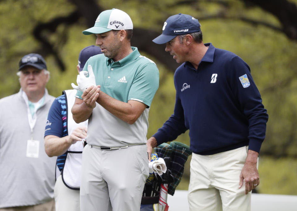 Sergio Garcia, left and Matt Kuchar, right, discuss, on the eighth hole, what had happened on the seventh green during quarterfinal play at the Dell Technologies Match Play Championship golf tournament, Saturday, March 30, 2019, in Austin, Texas. Garcia had an 8-foot putt to win the seventh hole and left it 4 inches short, a frustrating miss. Worse yet was what followed. Such a tap-in typically is conceded in the Dell Technologies Match Play, and the Spaniard walked up and casually rapped it left-handed. The ball spun around the cup, and he picked it up and walked off the green, assuming he remained 1 down through seven holes. One problem: Matt Kuchar never formally conceded the putt. (AP Photo/Eric Gay)