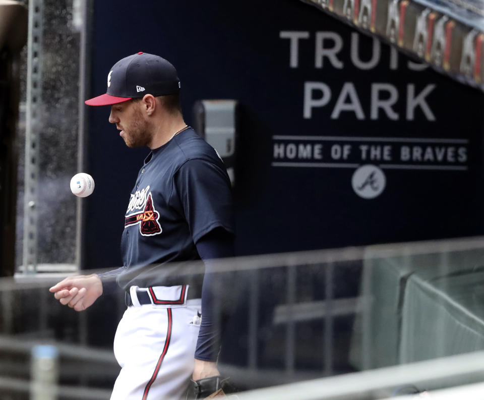 Atlanta Braves first baseman Freddie Freeman takes the field for an intrasquad baseball game Saturday, July 18, 2020, in Atlanta. It was Freeman's first game since his battle with COVID-19. (Curtis Compton/Atlanta Journal-Constitution via AP)