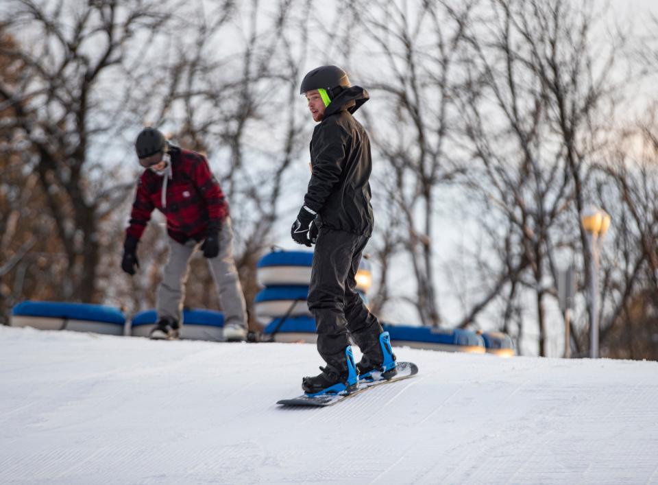 Matt Redner snowboards into the terrain park on Friday, Jan. 27, 2023, at the Snow Park at Alpine Hills in Rockford.