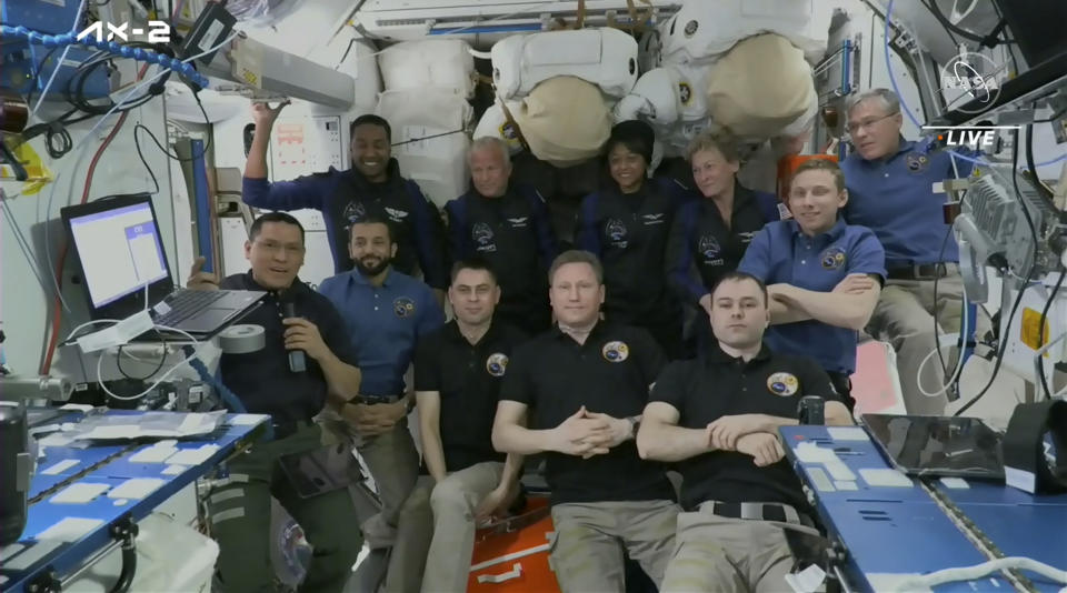 In this image from NASA TV, top row from left, Ali al-Qarni, John Shoffner, Rayyanah Barnawi, and Peggy Whitson, pose for a picture with current residents of the International Space Station, Monday, May 22, 2023. The space station rolled out the welcome mat for the two Saudi visitors, including the kingdom's first female astronaut. (NASA TV via AP)