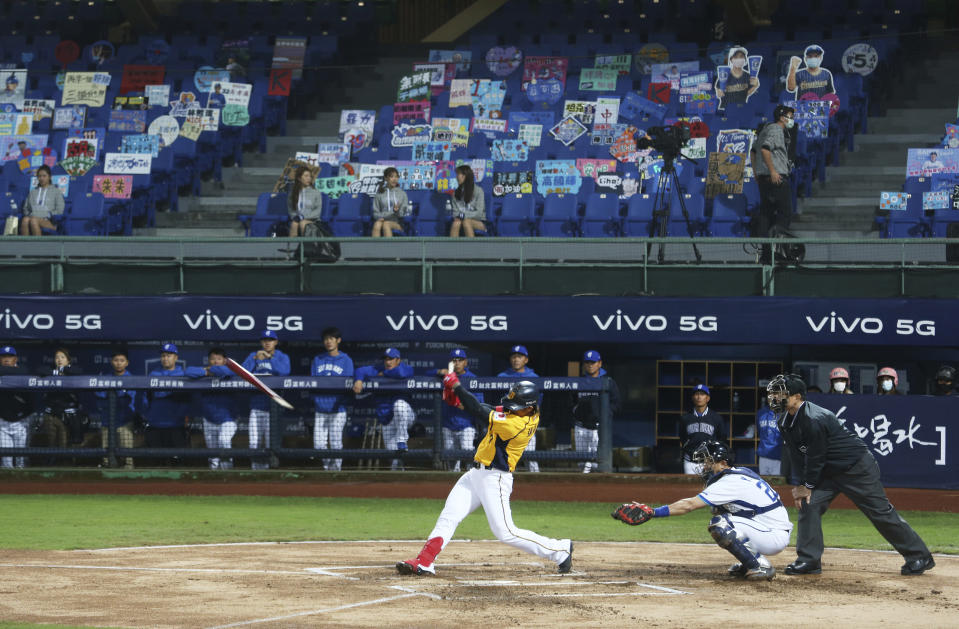 Players of Chinese Professional Baseball League play baseball with no audience at Xinzhuang Baseball Stadium in New Taipei City, Taiwan, Friday, April 24, 2020. Taiwan's five-team Chinese Professional Baseball League is barring spectators over concerns they would spread the deadly coronavirus, meaning games are played with plastic seats void of fans. (AP Photo/Chiang Ying-ying)