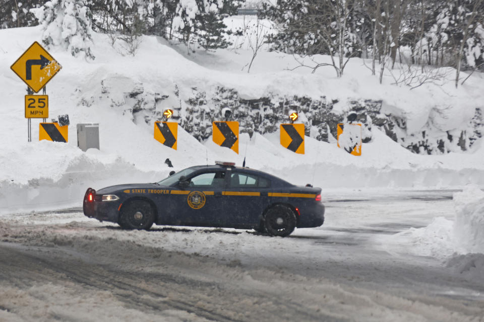 A New York State Trooper car block the entrance to route 198 after a winter storm rolled through Western New York Tuesday, Dec. 27, 2022, in Buffalo, N.Y. (AP Photo/Jeffrey T. Barnes)