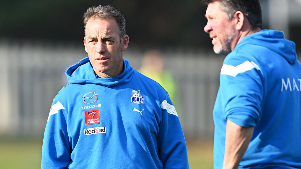 Alastair Clarkson is pictured with Brett Ratten in the foreground.