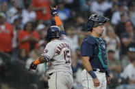 Houston Astros' Martin Maldonado gestures after scoring on his solo home run, next to Seattle Mariners catcher Cal Raleigh during the fifth inning of a baseball game Friday, July 22, 2022, in Seattle. (AP Photo/Ted S. Warren)