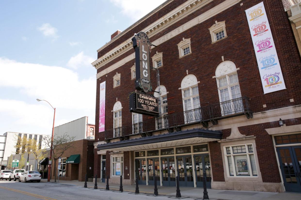 Signage celebrating the 100 year anniversary of the Mars Theater hangs on the Long Center, 111 North 6th St., Thursday, April 15, 2021 in Lafayette.