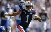 Auburn wide receiver Anthony Schwartz (1) catches a pass against Kentucky and carries for a first down during the first quarter of an NCAA college football game on Saturday, Sept. 26, 2020 in Auburn, Ala. (AP Photo/Butch Dill)