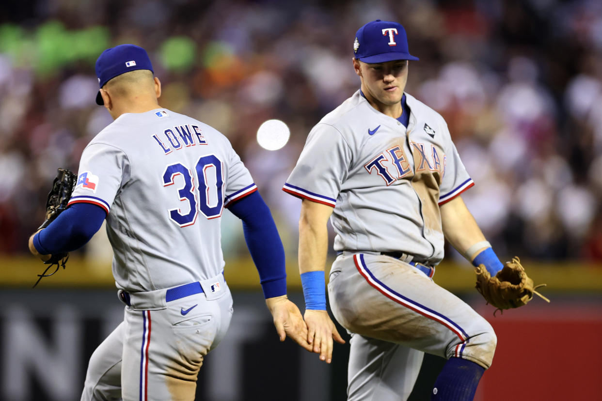 Nathaniel Lowe and Josh Jung celebrate the win. (Christian Petersen/Getty Images)